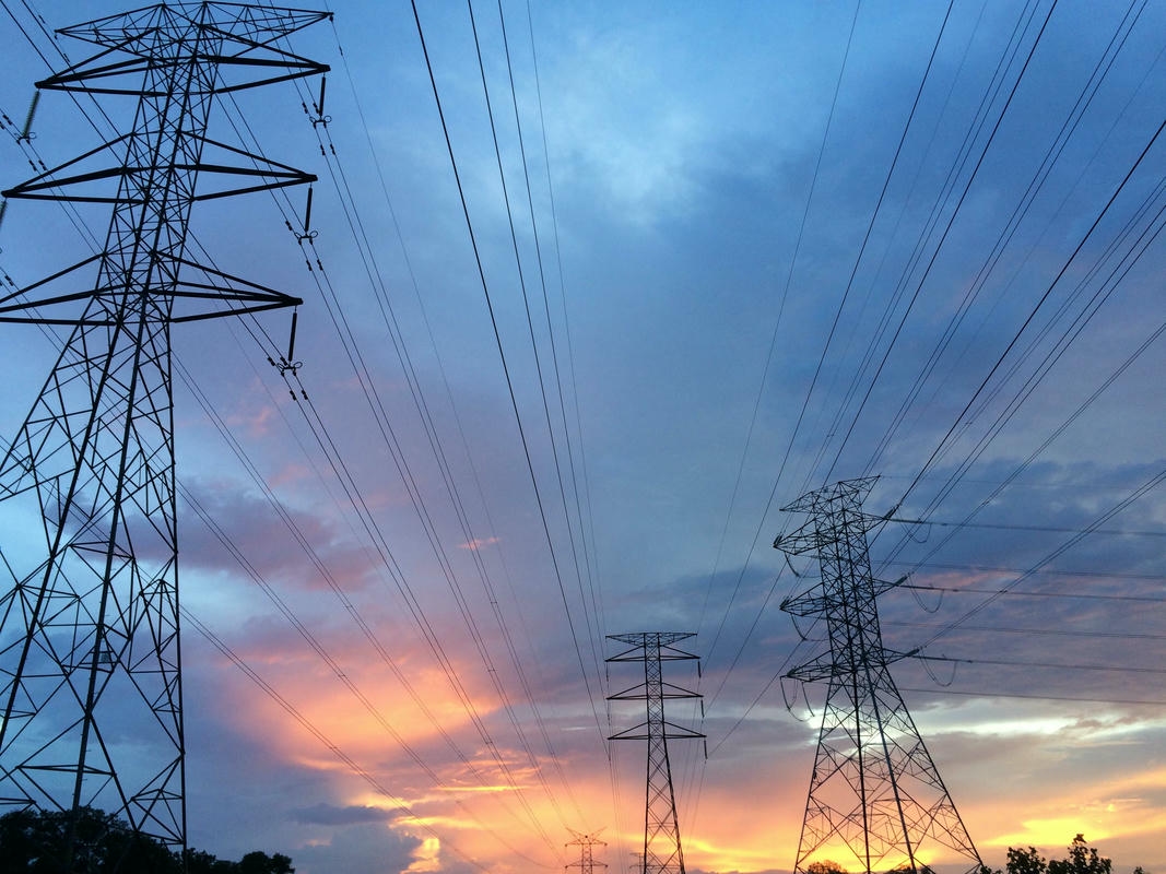 High-voltage power lines at sunset